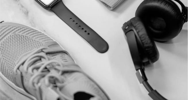 A shoe, a watch, and XX99 Mark I Headphones laying on a desk